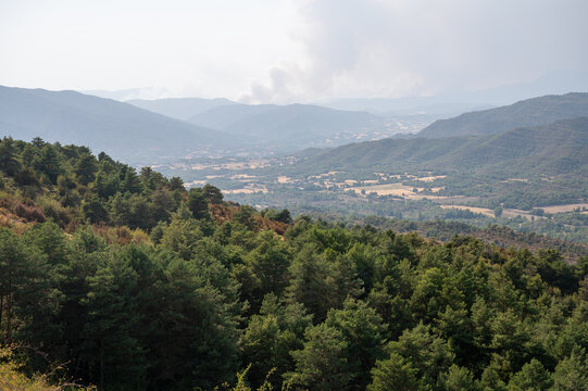 A column of wildfire smoke rises over the hills and valley of the Spanish Pyrenees foothills near Riglos in Aragon Spain a striking image of a forest fire and the growing threat of wildfires.