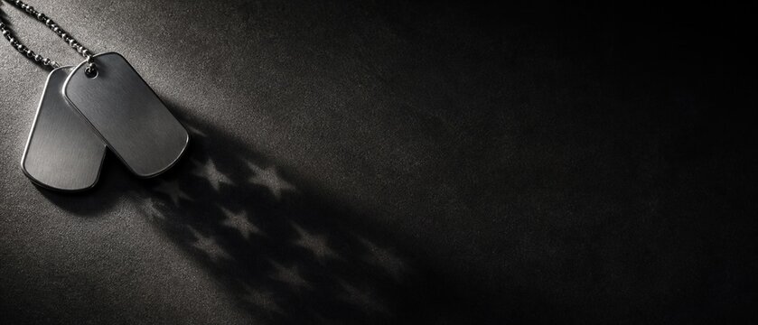 Military dog tags creating star shaped shadows on a dark backdrop representing honor and the legacy of veterans