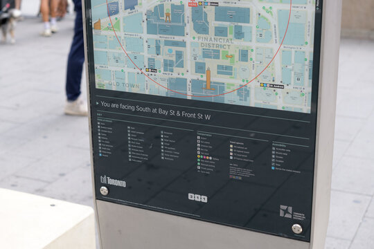 City of Toronto TO360 pedestrian wayfinding sign with directional orientation note, located here at Bay St and Front St W