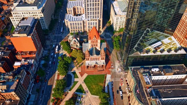 Circling around Copley Square and sunlit Trinity Church. Drone footage over Boston, Massachusetts, USA.