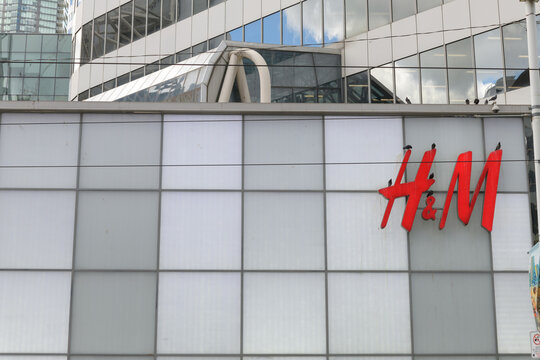 exterior building facade and sign of H&M, a clothing retailer chain, located here at the north end of CF Toronto Eaton Centre (220 Yonge St at Dundas St W)