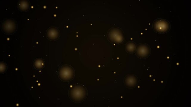 Golden particle dust and blurry glowing bokeh lights on black background concept