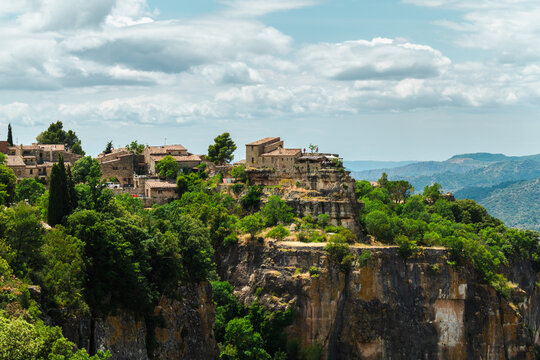 Stone village of Siurana dramatically perched on sandstone cliffs above deep valleys, iconic historic landmark