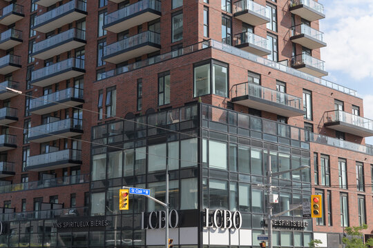 exterior building facade and sign of LCBO, a liquor store, located on ground floor of residential tower at 900 St Clair Av W (at Alberta Av), Toronto
