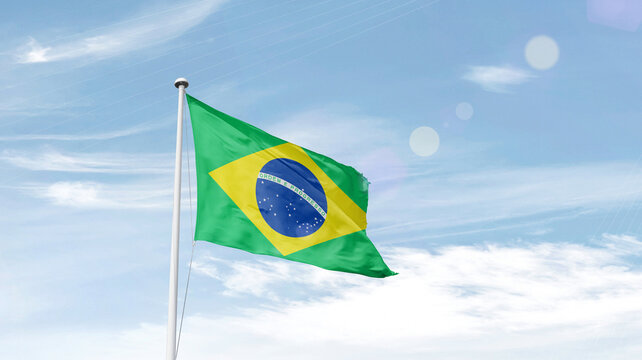 Brazil national flag waving in sky.