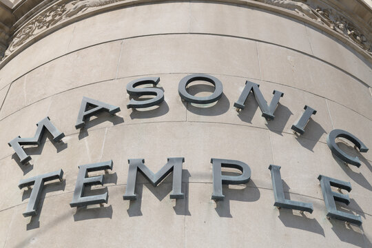 curved corner elevation of the Masonic Temple with metal sign at 888 Yonge Street in Toronto