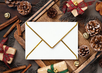 Blank Christmas envelope mockup near rustic wooden decor, Winter family greetings © katrinshine