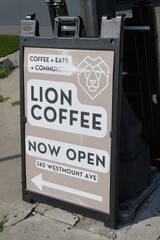 Obraz premium sidewalk a-frame sign with poster for Lion Coffee, a coffee shop, located at 140 Westmount Av, Toronto