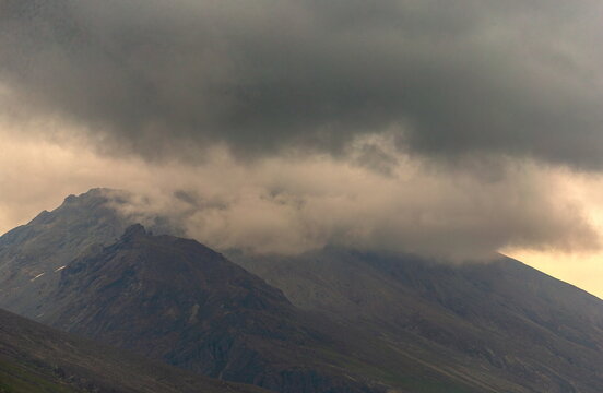 View of Burzil Pass with dramatic dark clouds gathering over the rugged mountain peaks in Astore, Gilgit Baltistan, Pakistan.
