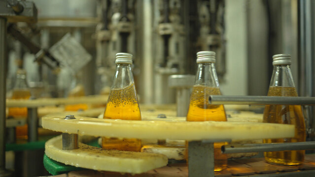 The fruit juice is bottled using automatic filling machines at the ready-to-drink fruit juice factory