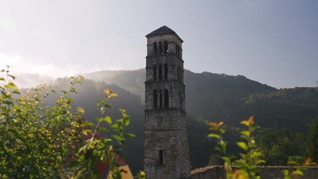 Ancient stone bell tower of Saint Luke church in Jajce Bosnia and Herzegovina during morning sunrise.