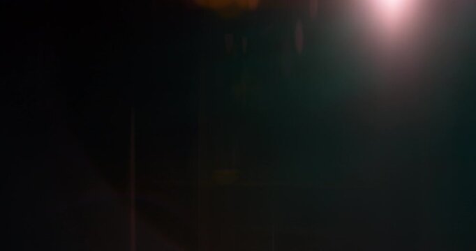 Anamorphic wide lens flare burst in slow motion, isolated on black background. Cinematic light streaks, ideal for VFX compositing, overlays, sci-fi transitions and film effects.