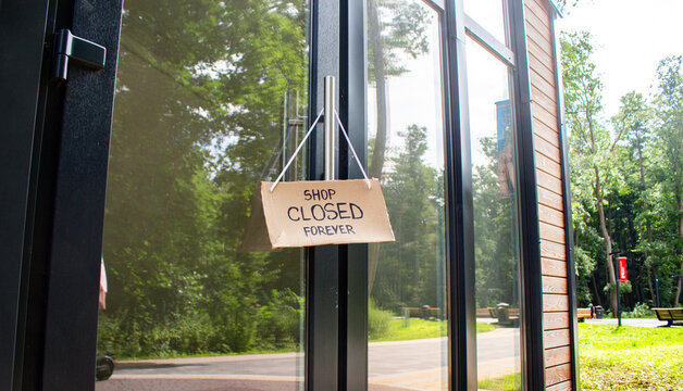 SHOP CLOSED FOREVER sign on private shop window. Small local retail business closes because of financial and economic crisis. Entrepreneurs faces market changes