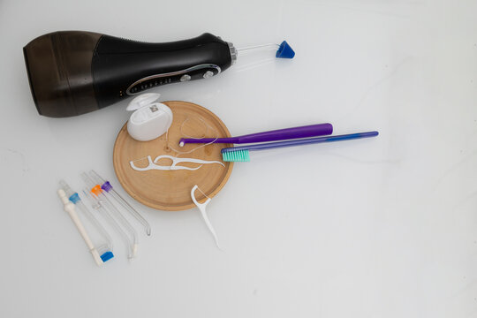 Dental care items on a clean bathroom countertop for at-home oral hygiene