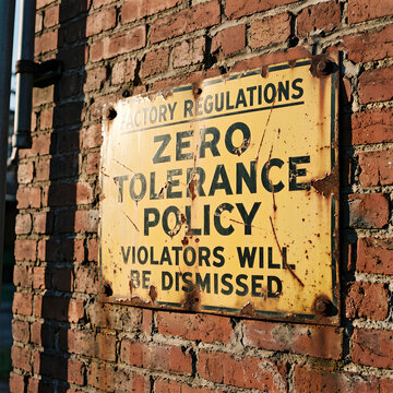 Rusty Factory Regulations Sign Zero Tolerance Policy Violators Dismissed