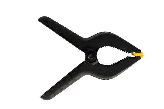 Close up view of a black clamp tool with yellow tip used for various tasks