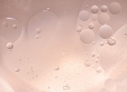 Abstract Pink water bubbles essential oil beauty collagen Serum Repair cream background.