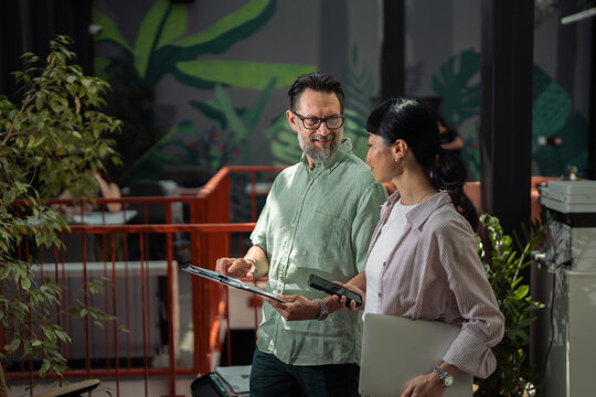 Business colleagues discussing project plans in modern office