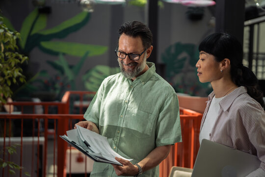 Business colleagues reviewing documents during a casual meeting