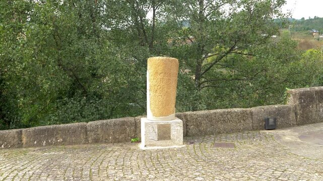 View of the Roman milestone beside Ponte da Cigarrosa in Pet&iacute;n, a restored marker from the ancient Via Nova route through Valdeorras, preserving traces of Roman heritage in Galicia, Spain