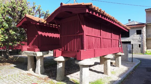 Traditional Galician h&oacute;rreos in A Forxa, historic raised granaries used for storing crops in the rural landscape of Porqueira, Ourense, Spain