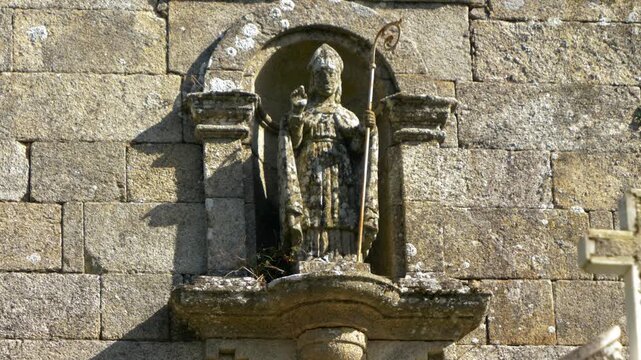 Carved bishop holding a crosier on San Marti&ntilde;o church in Porqueira, Ourense, Galicia