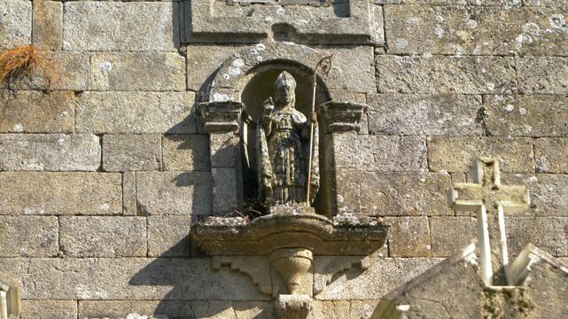 Stone carving of bishop holding a crosier at San Marti&ntilde;o church in Porqueira, Galicia