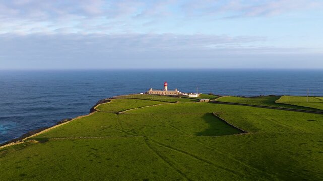 Farol do Albarnaz Lighthouse Stands In The Northern Parish Of Ponta Delgada On Flores Island In The Azores, Portugal. Aerial Sideways Shot