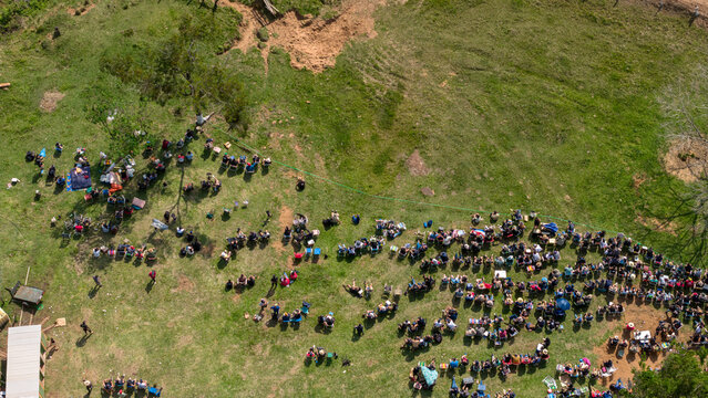 Aerial view of Rally Paraguay with spectators gathered on a grassy hillside to watch the race in Nueva Alborada, Itapua Department, Paraguay.