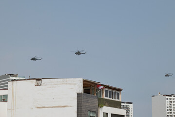Military helicopters flying over city rooftops with peruvian flag © JF:Carpio