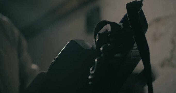 Man uses a retro walkie talkie for communication inside an underground wartime bunker, creating a cinematic scene with atmospheric lighting.