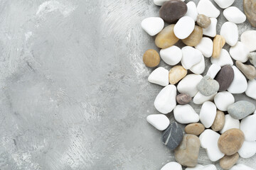 White pebble stones on concrete background, top view © Liami