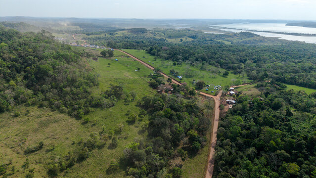 Aerial view of the Rally Paraguay dirt track winding through lush green hills and forests in the rural landscape of Nueva Alborada, Itapua Department, Paraguay.