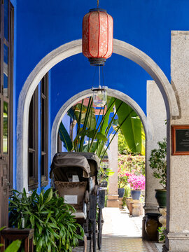 Vintage rickshaw under red lantern in Cheong Fatt Tze Mansion, Penang