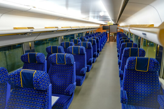 Empty seating with vibrant blue fabric and dots offers a cozy atmosphere for passengers traveling