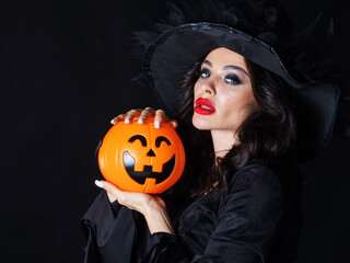 Beautiful young woman wearing witch costume holding a broomstick © yellowj