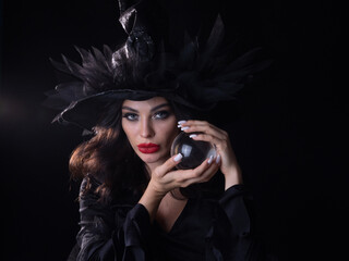 Beautiful young woman wearing witch costume holding a broomstick © yellowj