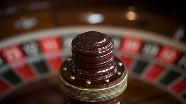 Close-up of Roulette Wheel with Red and Black Numbered Segments on Gaming Table