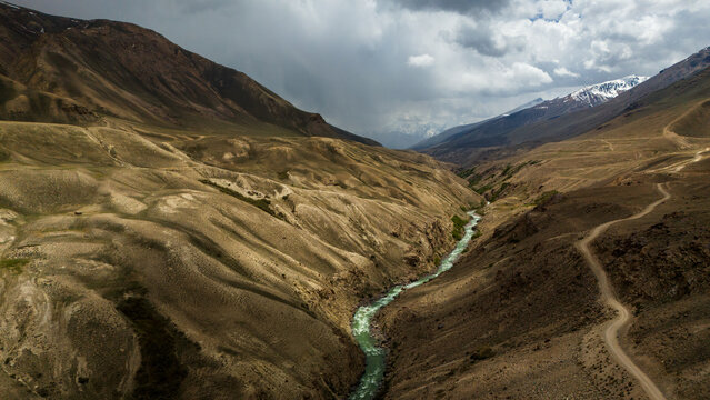 Aerial view of the Panj River winding through the rugged, arid mountain landscape of the Wakhan Corridor in Wakhan, Badakhshan, Afghanistan.