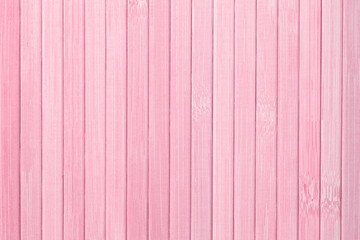 Naklejka premium pink backdrop: close up of bamboo rolling mat made of planks