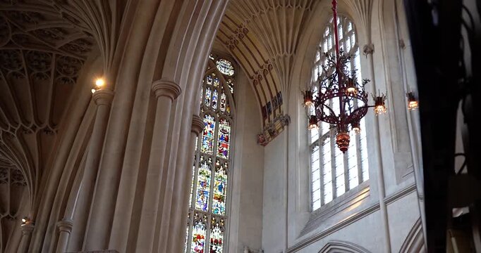 Decorative ceiling and stained glass window of Abbey Church in Bath, England