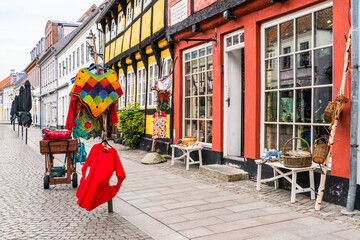Artisan street character combines a colorful craft display, cobbled paving and half timbered facade in Ribe for local culture, creative tourism and small business themes. © Nimbus Works