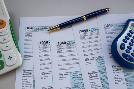 US Individual Income Tax Return Form 1040 with Calculator and Pen for Annual Tax Filing Concept