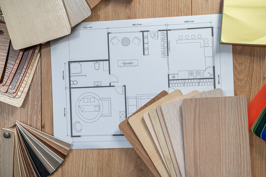 Architectural Blueprint with Wooden Material Samples and Drawing Compass for Interior Design