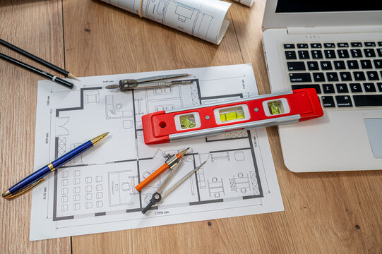 Top View Architectural Blueprint Floor Plan with Laptop Spirit Level and Tools Flat Lay Desk