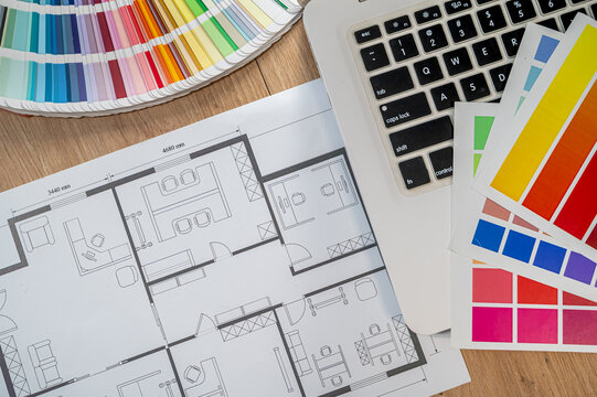 Flat Lay House Blueprint Draft with Laptop Computer Bright Color Swatches and Designer Tools