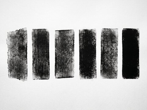 A set of six vertical textured black ink rectangles painted on a plain white paper background