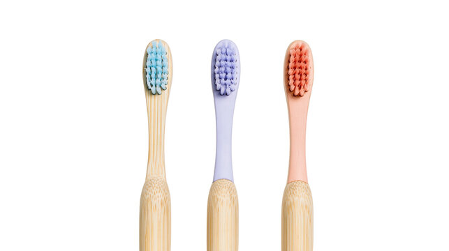 Three bamboo toothbrushes with colorful bristles in blue purple and pink