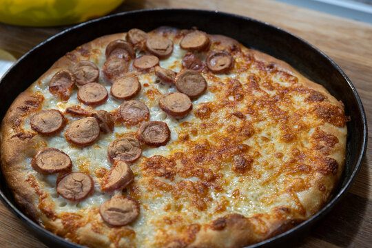 Homemade white pizza with sausage and cooked ham
