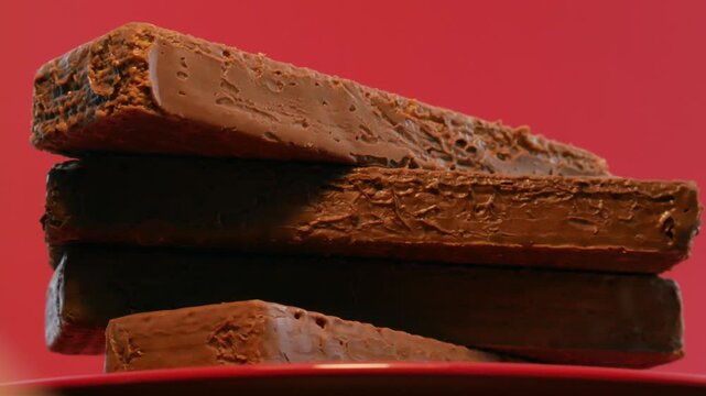 Chocolate wafers on a red plate and a red background. Сonfection, sweets and candies. Tasty and delicious food.